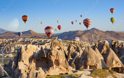 Hot air balloons fly in clear morning sky near Goreme, Kapadokya, Turkey