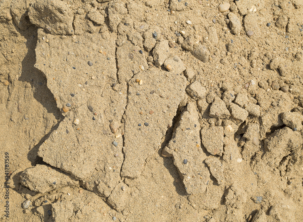 Fototapeta premium Sand, small rocks and cracks - texture