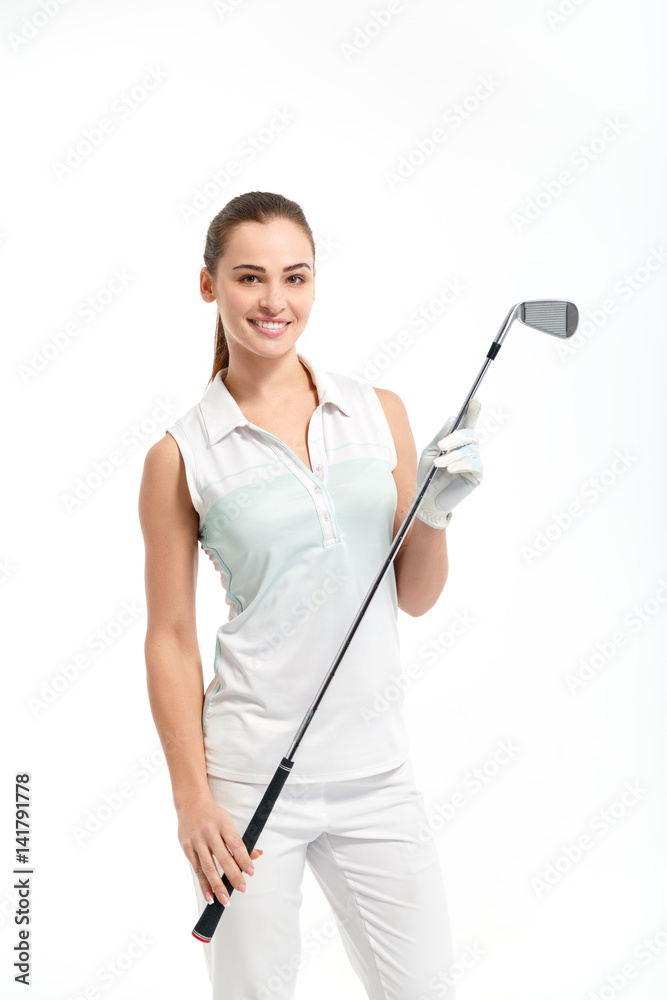 Pretty woman golfer posing with golf club on white background in studio Pretty woman golfer posing with golf club on white background in studio