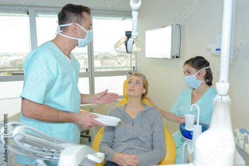 dentist curing a woman patient in the dental office