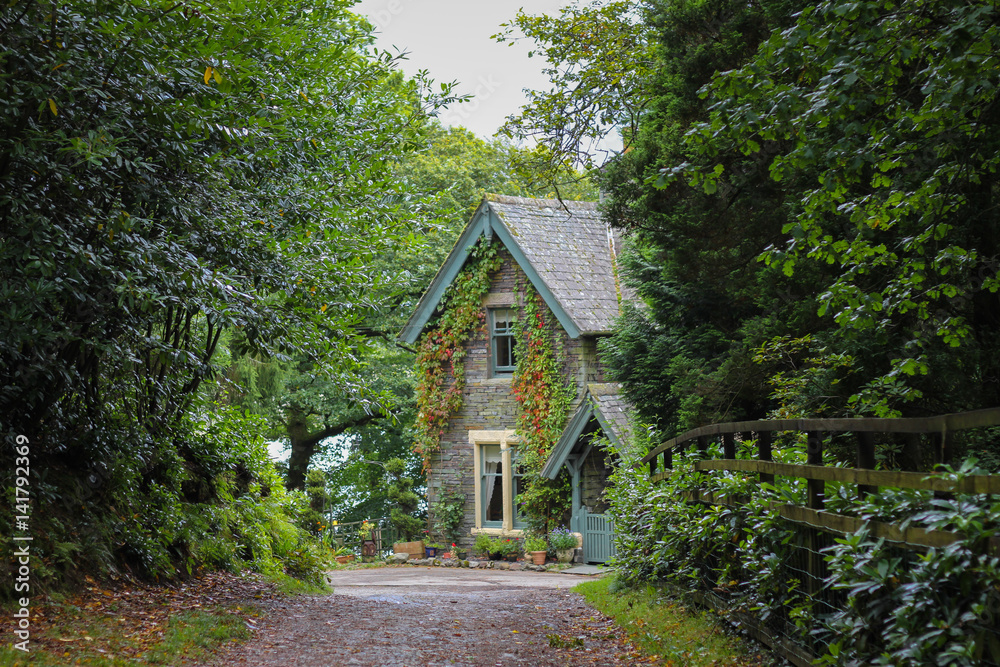 Old traditional house in greenery and flowers in Keswick, Lake District, England Old traditional house in greenery and flowers in Keswick, Lake District, England