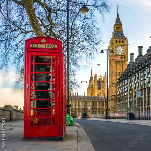 London  England - The iconic british old red telephone box with the Big Ben at background in the center of London