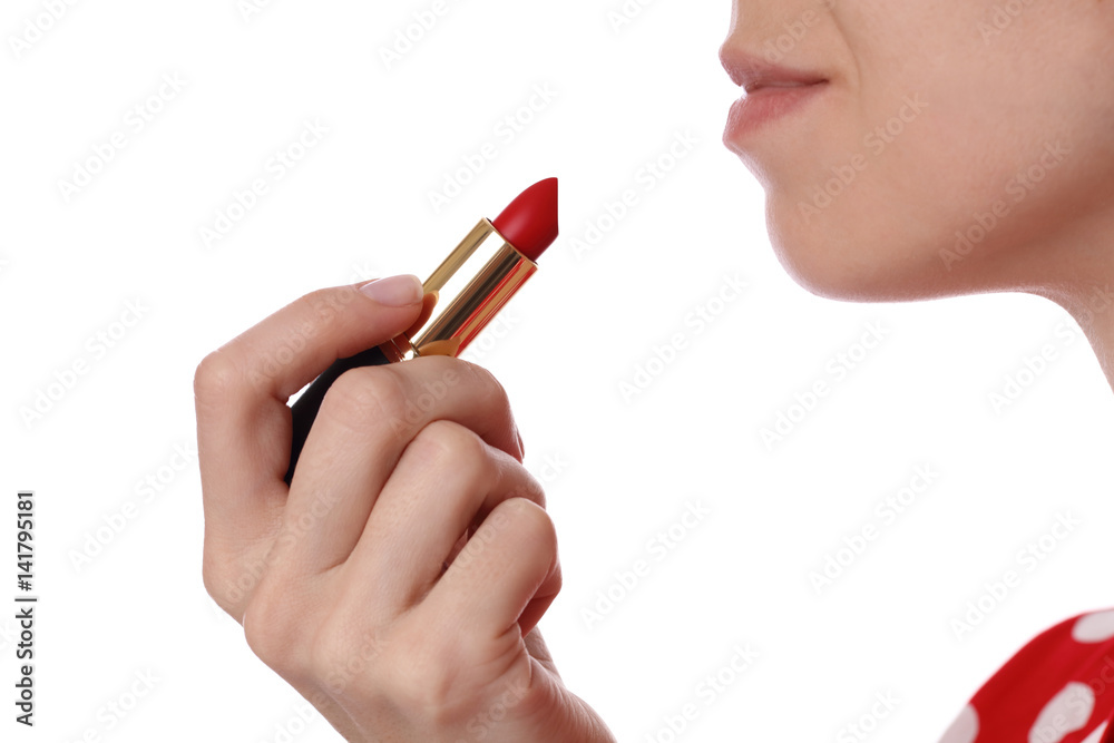 Obraz premium Woman holding red lipstick in her hand. Beauty and fashion concept