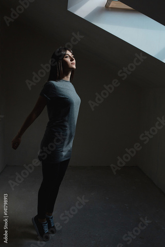 Pretty brunette woman posing in dark room © arthurhidden