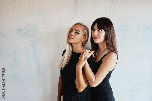 Two pretty woman in a black dress indoor © arthurhidden