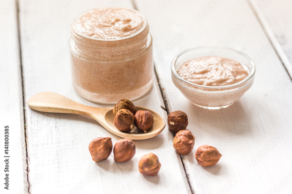 natural scrub with hazelnut on light table background natural scrub with hazelnut on light table background