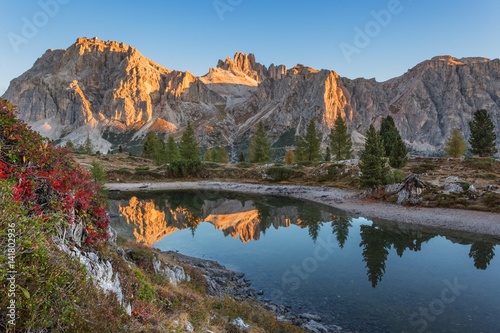 Europe, taly, Veneto, Belluno. Lake Limedes with the colors of autumn. In the background Lagazuoi and Fanis illuminated by the rays of the morning sun, Dolomites photo