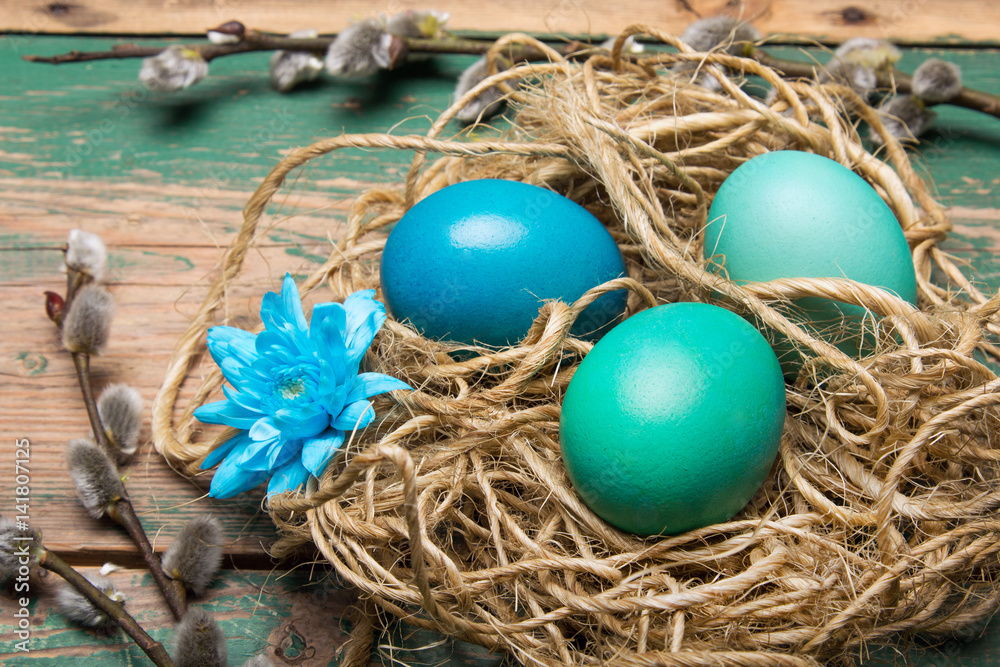 Easter background with eggs, nest and catkins on old wooden background, copy space Easter background with eggs, nest and catkins on old wooden background, copy space