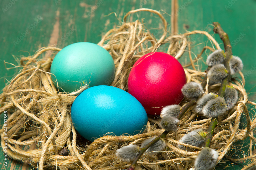 Easter background with eggs, nest and catkins on old wooden background. Copy space Easter background with eggs, nest and catkins on old wooden background. Copy space