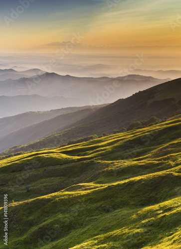 Ligurian Apennines, Piedmont, Italy. The sunset lights up the hillside of Mount Ebro. photo