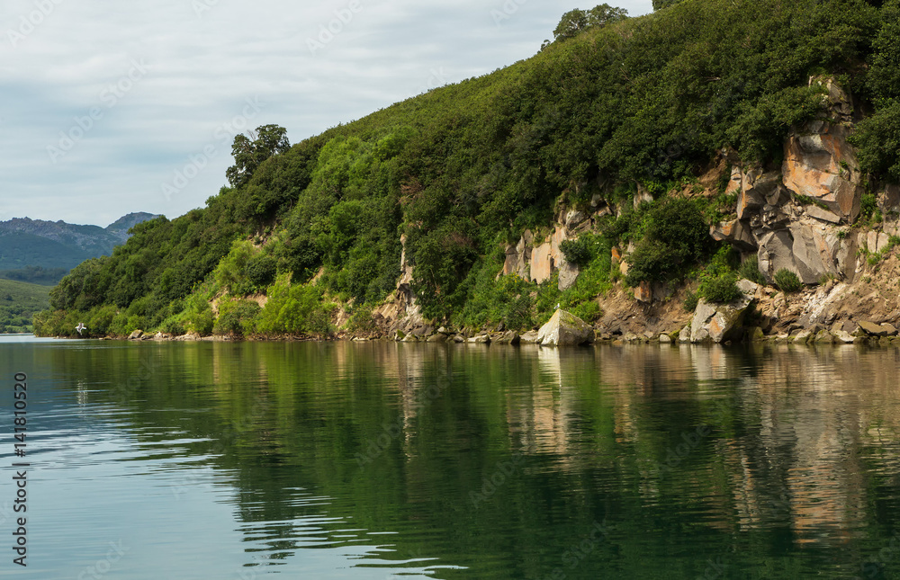 Beautiful coast of Kurile Lake is reflected in the water. Beautiful coast of Kurile Lake is reflected in the water.