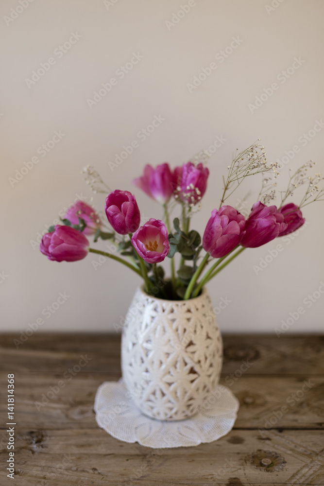 bouquet of pink tulips in white vase