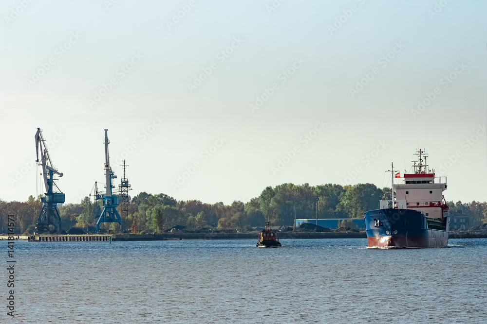 Blue cargo ship leaving the port of Riga