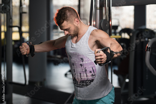 Bodybuilder Exercising Chest On Machine © Jale Ibrak