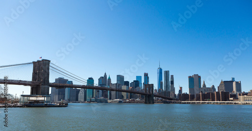 View of Brooklyn Bridge and Manhattan skyline WTC Freedom Tower from Dumbo, Brooklyn. Brooklyn Bridge is one of the oldest suspension bridges in the USA