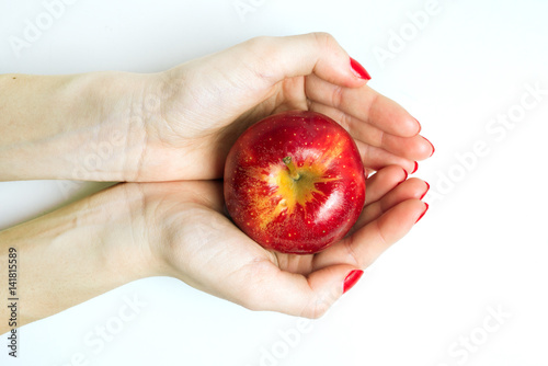 hands holding an apple
