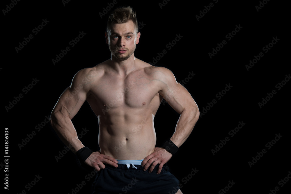 Young Bodybuilder Flexing Muscles Isolate On Black Blackground