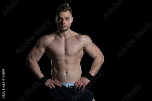 Young Bodybuilder Flexing Muscles Isolate On Black Blackground