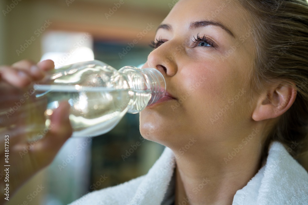 Beautiful woman drinking water after workout Beautiful woman drinking water after workout