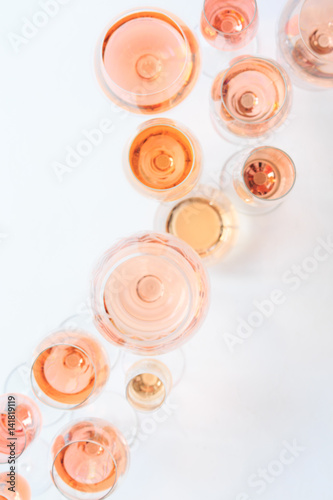 Fototapeta Naklejka Na Ścianę i Meble -  Many glasses of rose wine at wine tasting. Concept of rose wine and variety