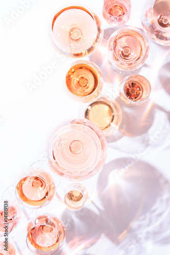 Many glasses of rose wine at wine tasting. Concept of rose wine and variety