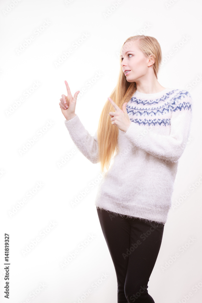 Teenage blonde woman pointing at copyspace Teenage blonde woman pointing at copyspace