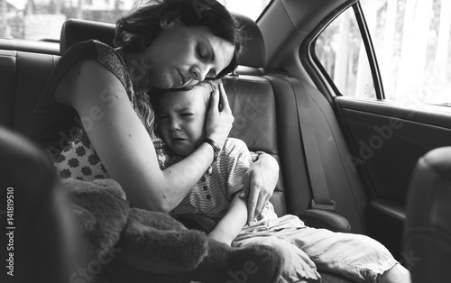 Mother Soothe Her Son Crying in the Car photo