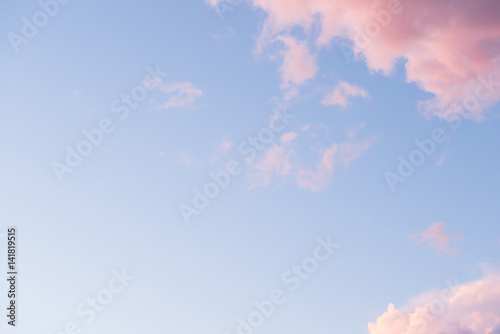 Fototapeta Naklejka Na Ścianę i Meble -  Wisps of pink sunset clouds against a blue sky
