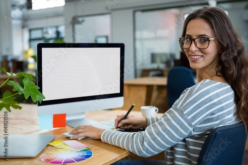 Female graphic designer working at desk