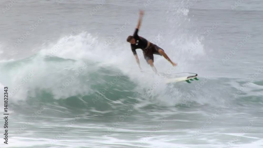Surfer almost lands an aeriel trick and then falls off his surfboard Surfer almost lands an aeriel trick and then falls off his surfboard