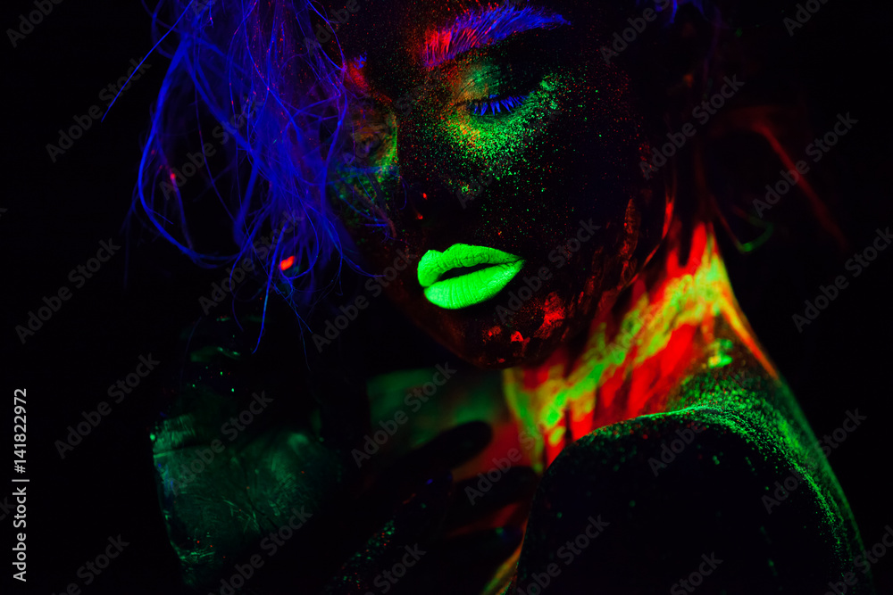 Beautiful extraterrestrial model woman with blue hair and green lips in neon  light. It is close