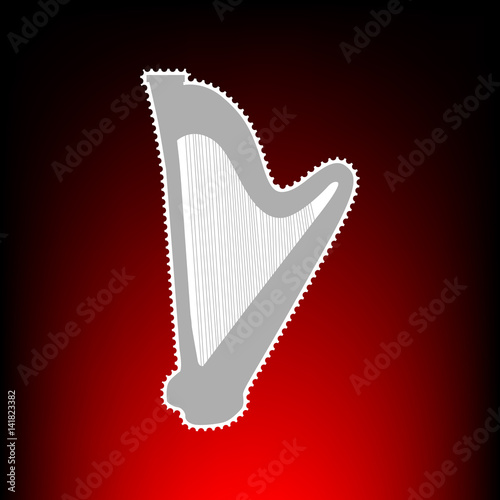 Musical instrument harp sign. Postage stamp or old photo style on red-black gradient background.