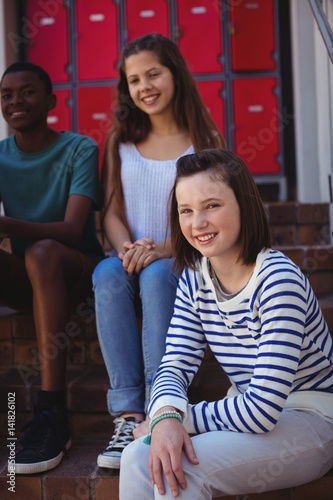 Portrait of students sitting on staircase