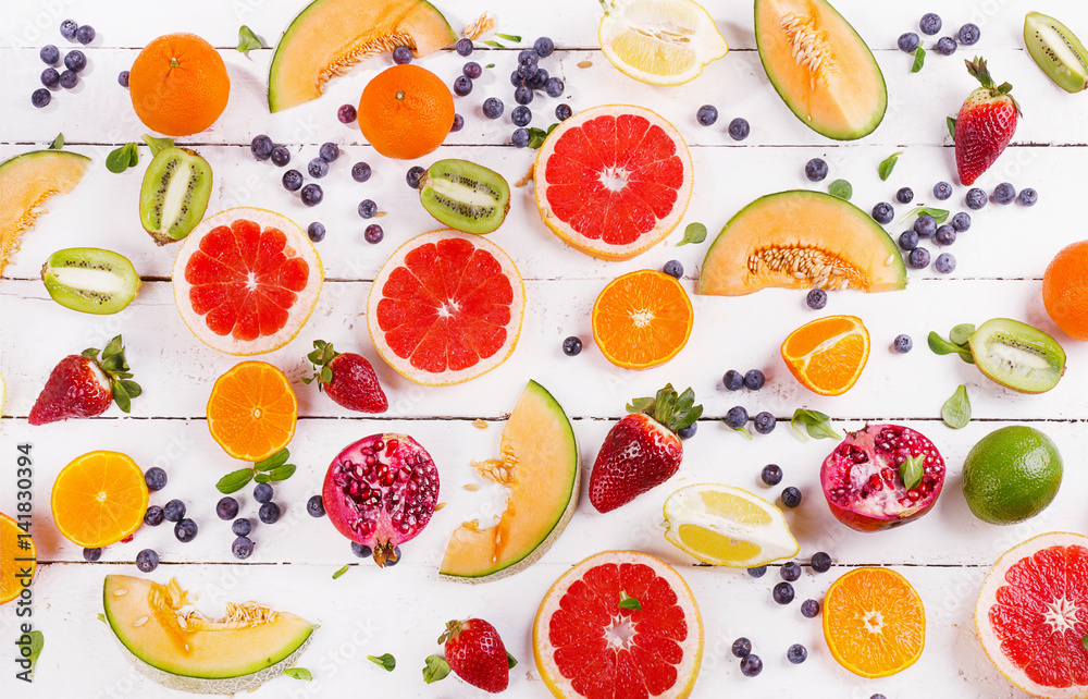 Naklejka Fresh mixed fruits on white wooden background. Healthy diet eating concept. Pattern.