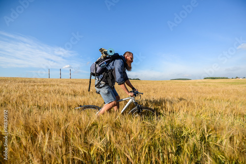 hipster man on a bicycle in the field © areporter