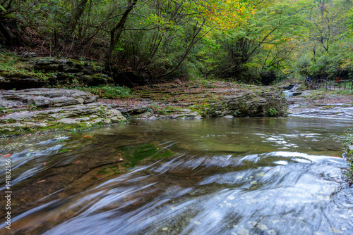 Stream Flowing Through Rocks in forest.