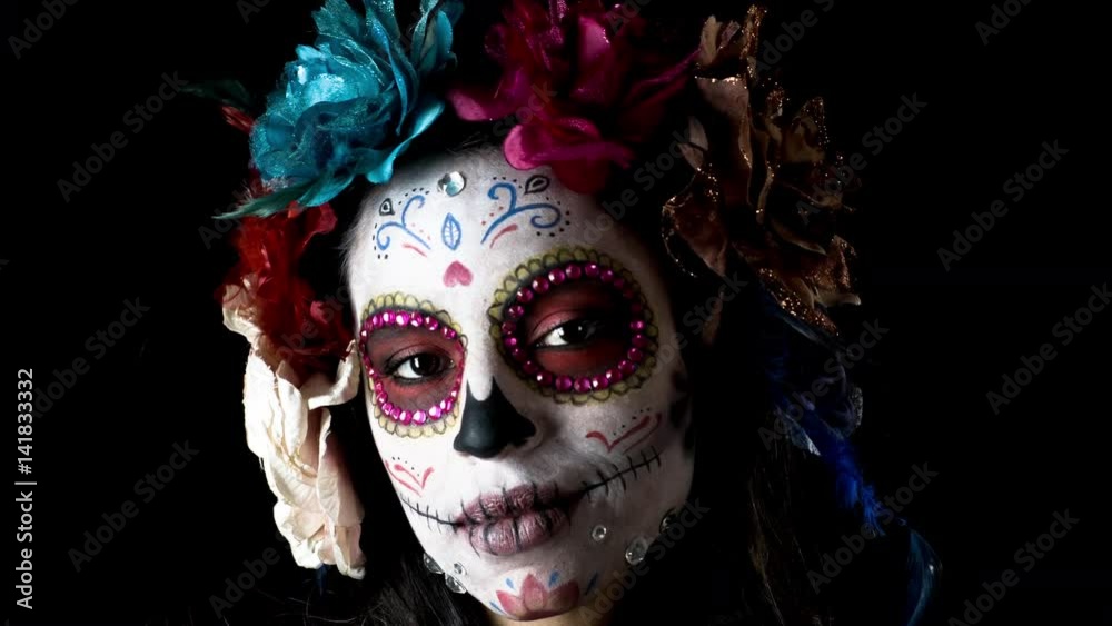 beautiful woman with custom designed candy skull mexican day of the dead face make up