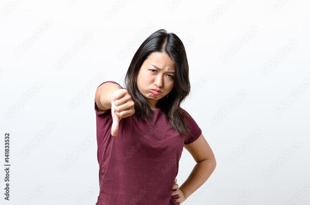 Rebellious negative woman giving a thumbs down Rebellious negative woman giving a thumbs down