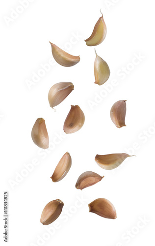 Falling garlic cloves isolated on white background.