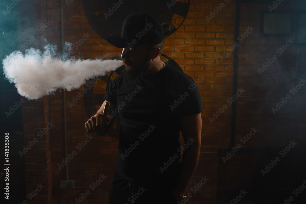 Fototapeta premium Man vaping an electronic cigarette