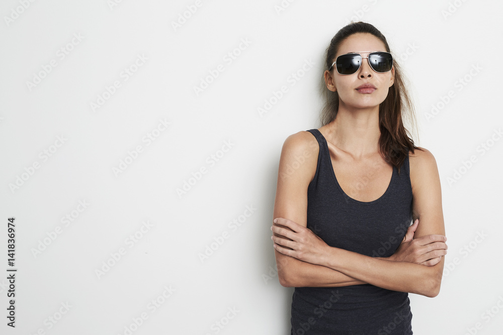 Cool attitude girl in vest and shades, portrait Cool attitude girl in vest and shades, portrait