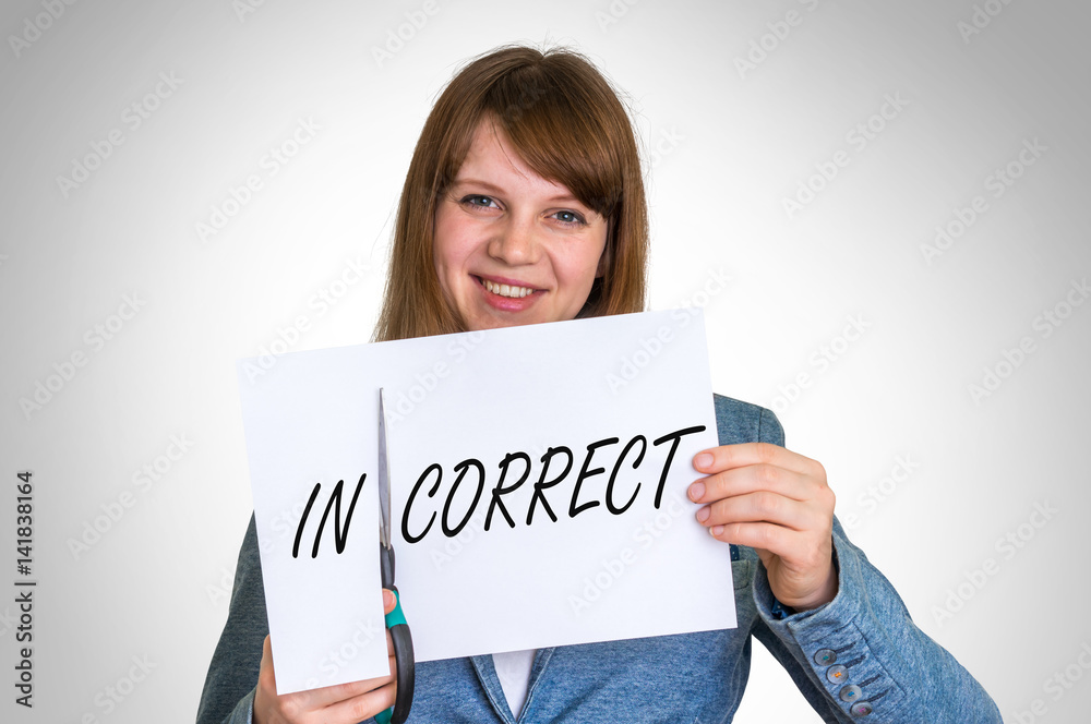 Woman cutting paper by scissors with incorrect word Woman cutting paper by scissors with incorrect word