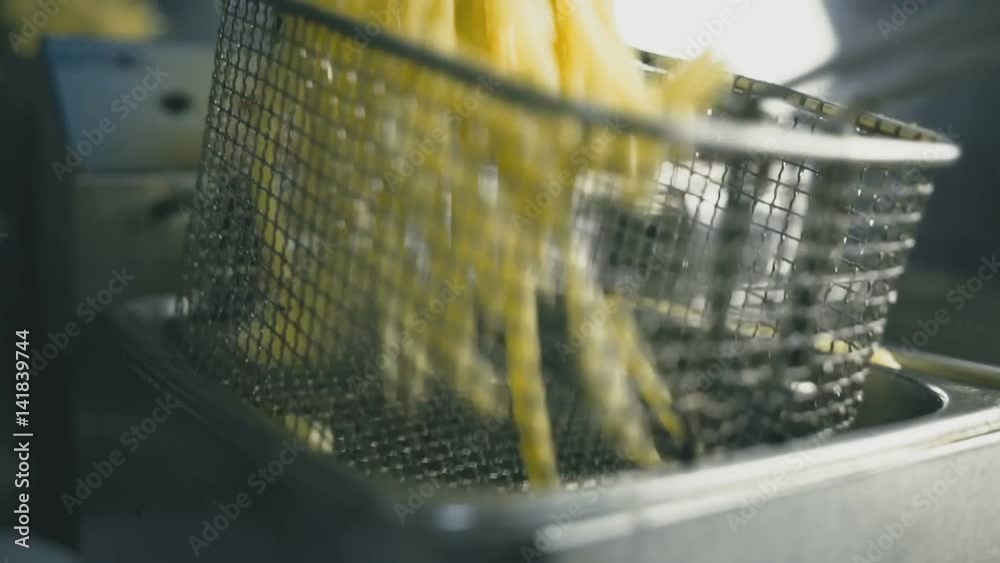 French fries in the deep fryer close-up