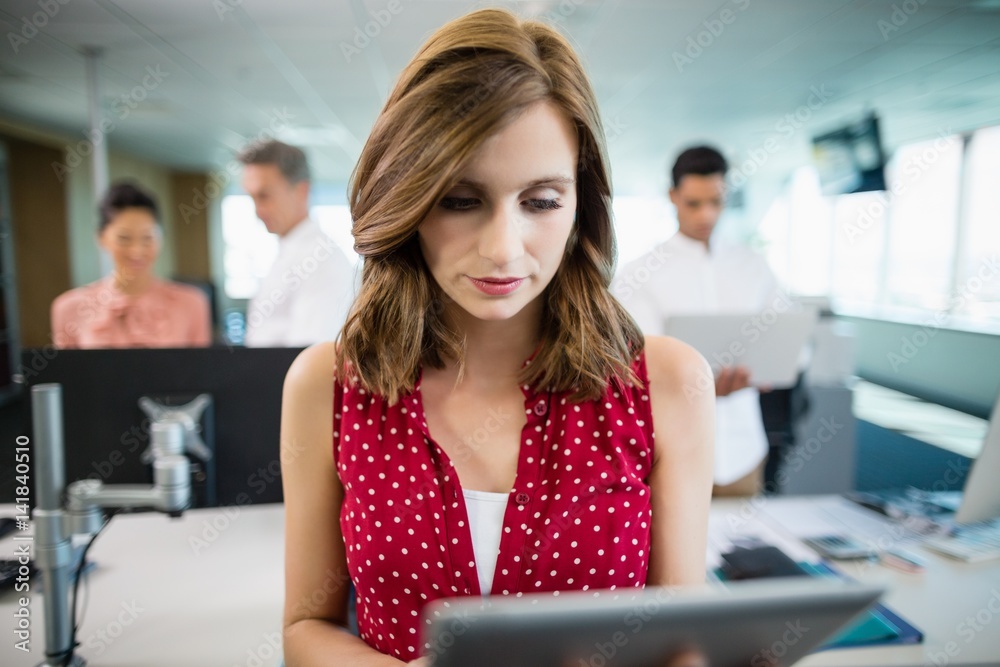 Fototapeta premium Business executive using digital tablet at desk