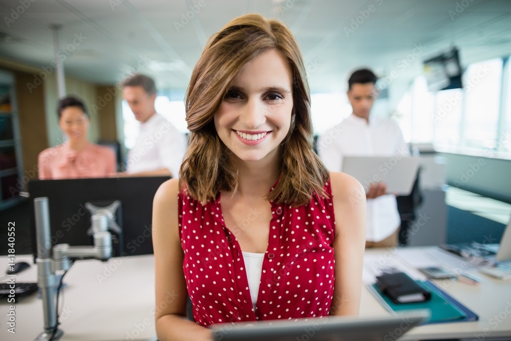 Fototapeta premium Smiling business executive using digital tablet 