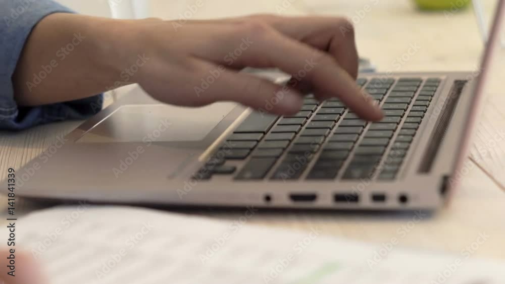 Woman with laptop counting bills sitting by table at home
Woman with laptop counting bills sitting by table at home
