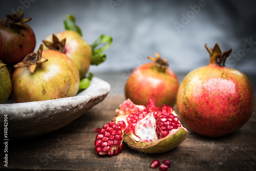 Pomegranate fruit arranged on wooden table top