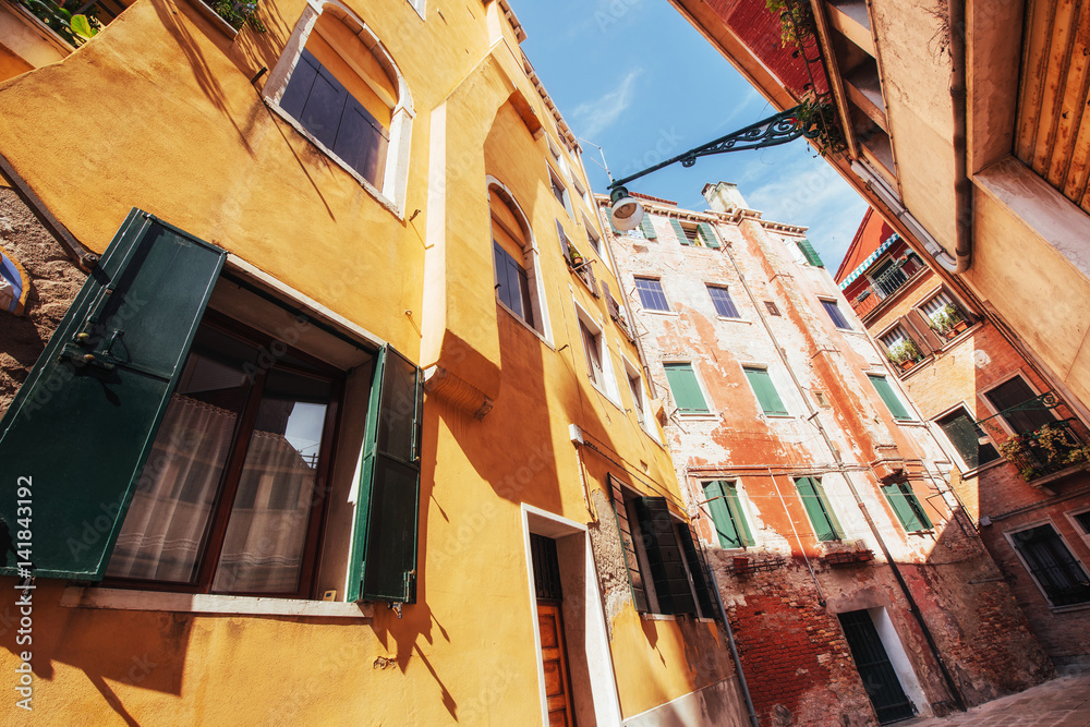 View of typical Venetian canal and colourful buildings in Venice, Italy