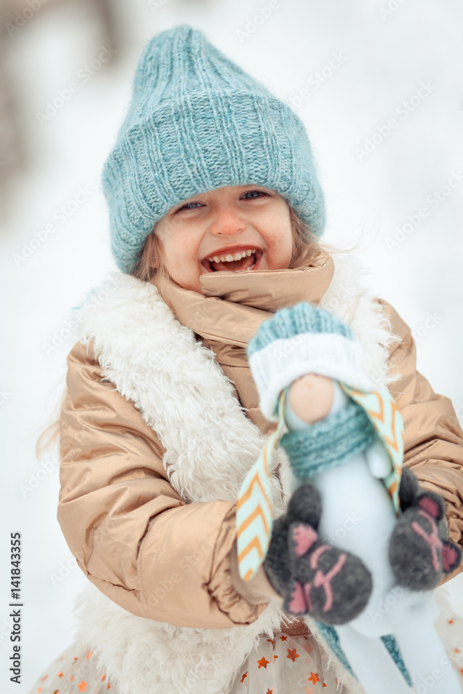 Portrait of beautiful happy girl in blue hat in winter snow park, Portrait of beautiful happy girl in blue hat in winter snow park,