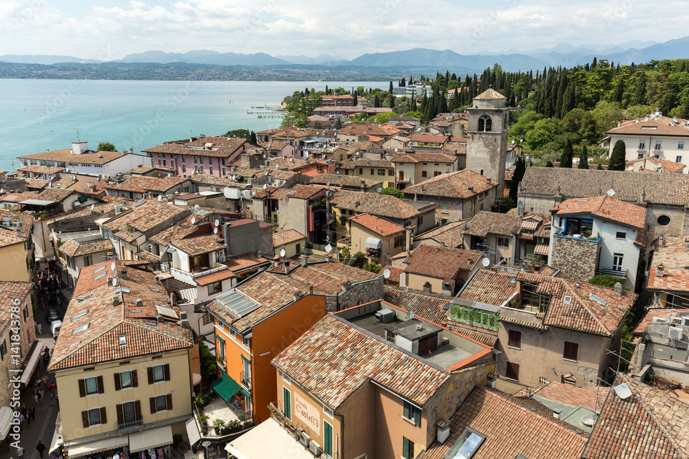 View of colorful old building in Sirmione and Lake Garda from Scaliger castle wall, Italy
